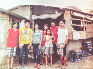 The Gadoa family in front of their old house before the Super Typhoon Yolanda damaged their properties.